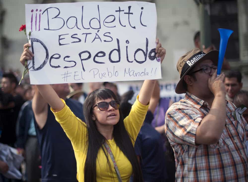 A protestor holds a sign saying "Baldetti you're fired" during a protest in Guatemala City's central plaza, April 25, 2015. 
