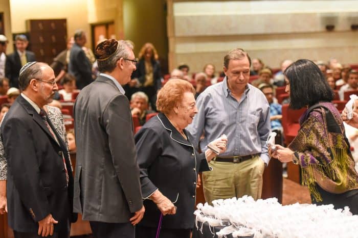 Magda de Davidovich, center, and other holocaust survivors and their families receive an honorary recognition at the Jewish Center's synagogue, Tuesday, September 01.