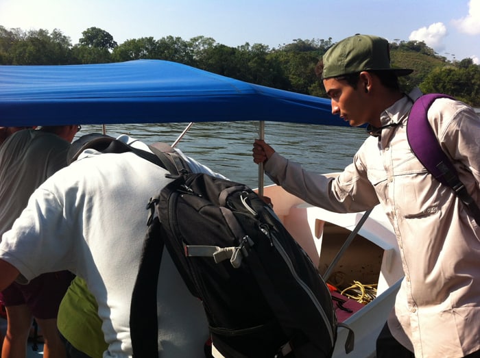 Tour guide Boanerges Gamboa helps tourists climb into the boat.