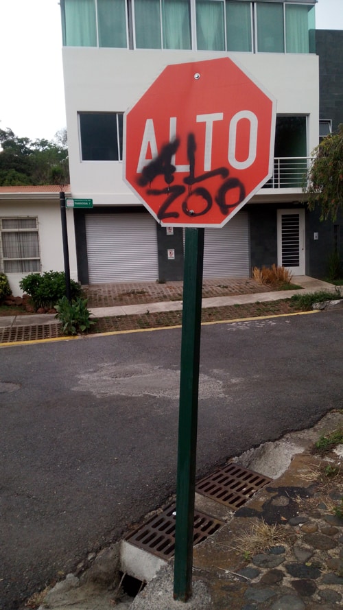 Graffito on a stop sign near the zoo says "Stop the Zoo."