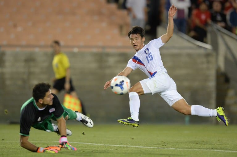 Kim Min-woo (R) of South Korea and Costa Rica's goalkeeper Leonel Moreira