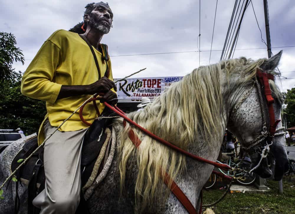 Rider dressed in Rasta colors parading on a decorated horse during Puerto Viejo’s Rasta Tope