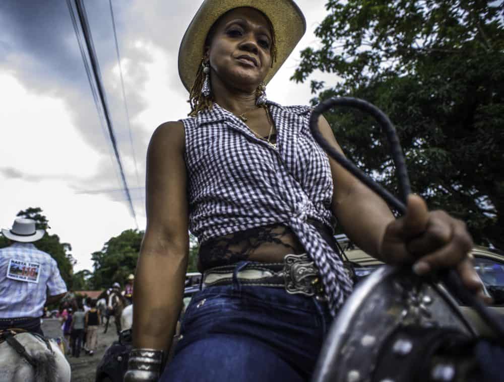 Smiling rider posing with their horse at the end of Puerto Viejo’s Rasta Tope parade