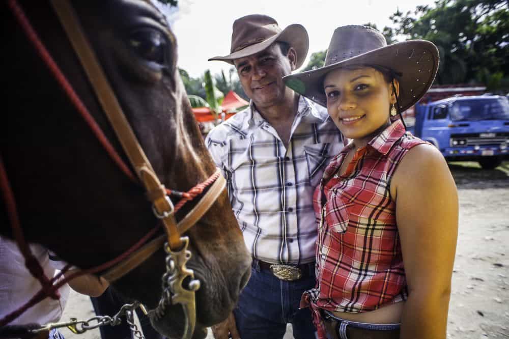 Smiling rider posing with their horse at the end of Puerto Viejo’s Rasta Tope parade