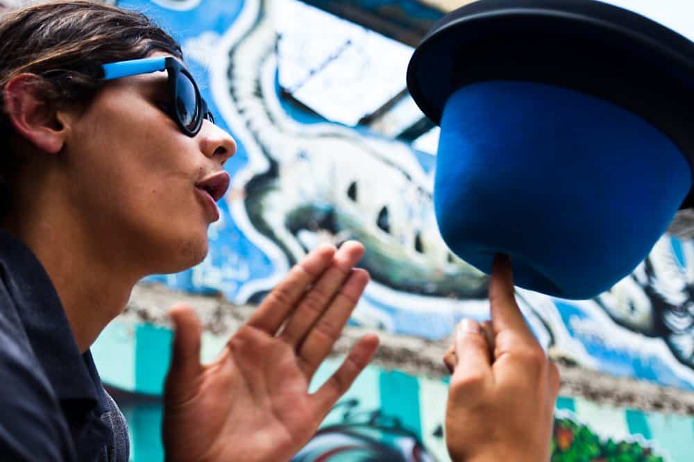 Magician performing tricks for an excited crowd.