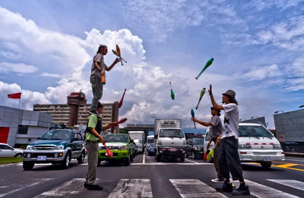 Performer juggling flaming torches on a city street in San Jose Costa Rica