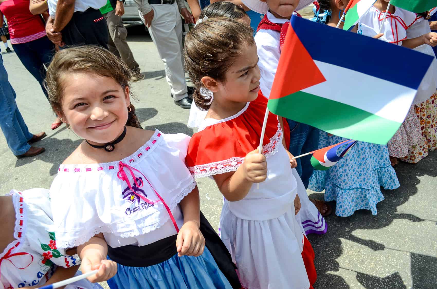 Children in traditional dress wave the Guanacaste flag at the 190th anniversary of the annexation of the Partido de Nicoya by Costa Rica, 2014.