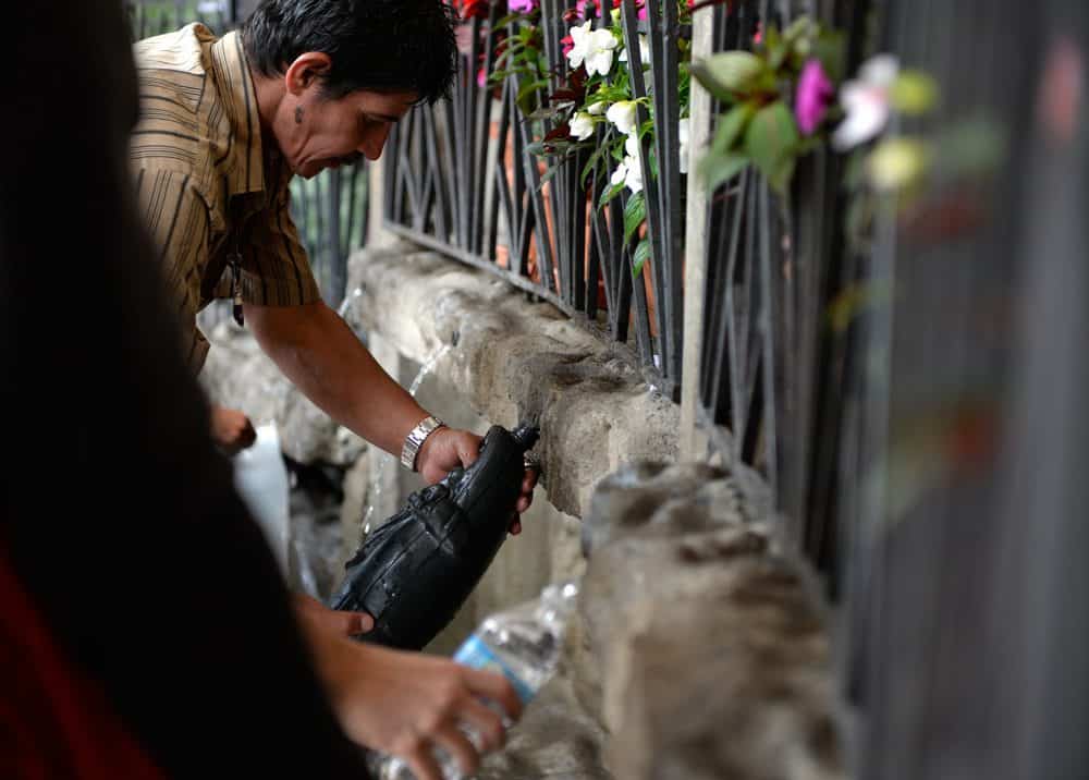 Filling water bottles during the Romeria - Costa Rica largest religious event