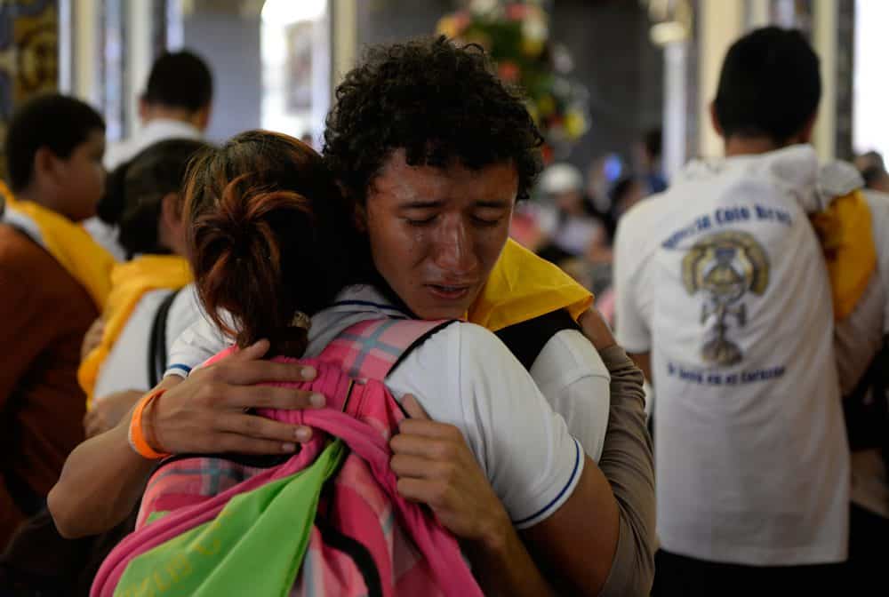 The Costa Rica faithful hugging during the Romeria, the country's largest religious event