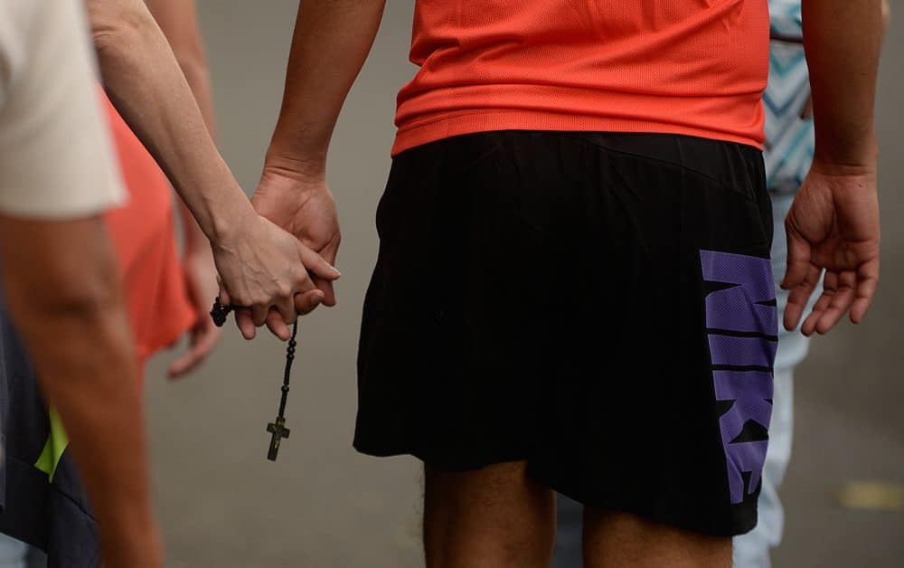 A Costa Rican couple holds hands along with a rosary during their pilgrimage to Cartago.