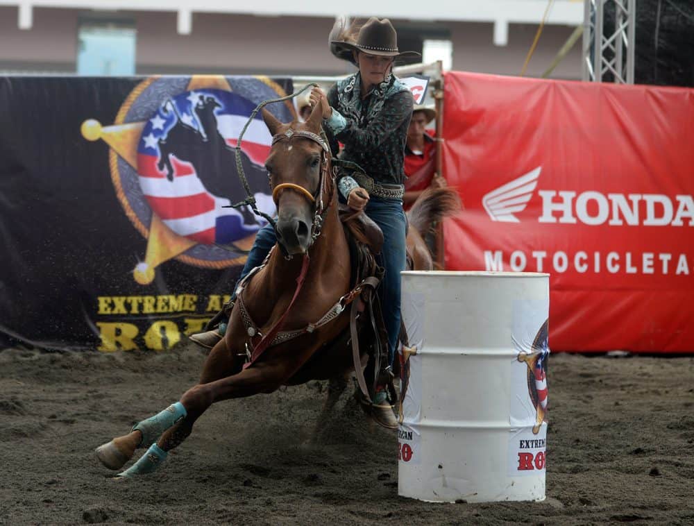 A Costa Rican cowboy riding a bull at a lively rodeo event