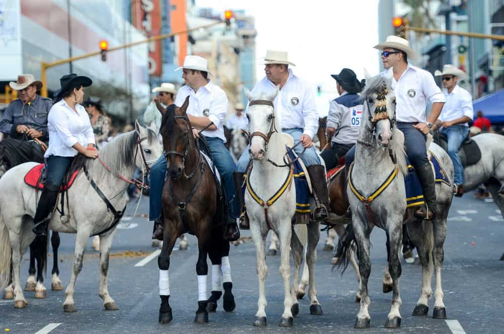 Cowboys stop to talk at Costa Rica National Horse Parade in the capital San Jose