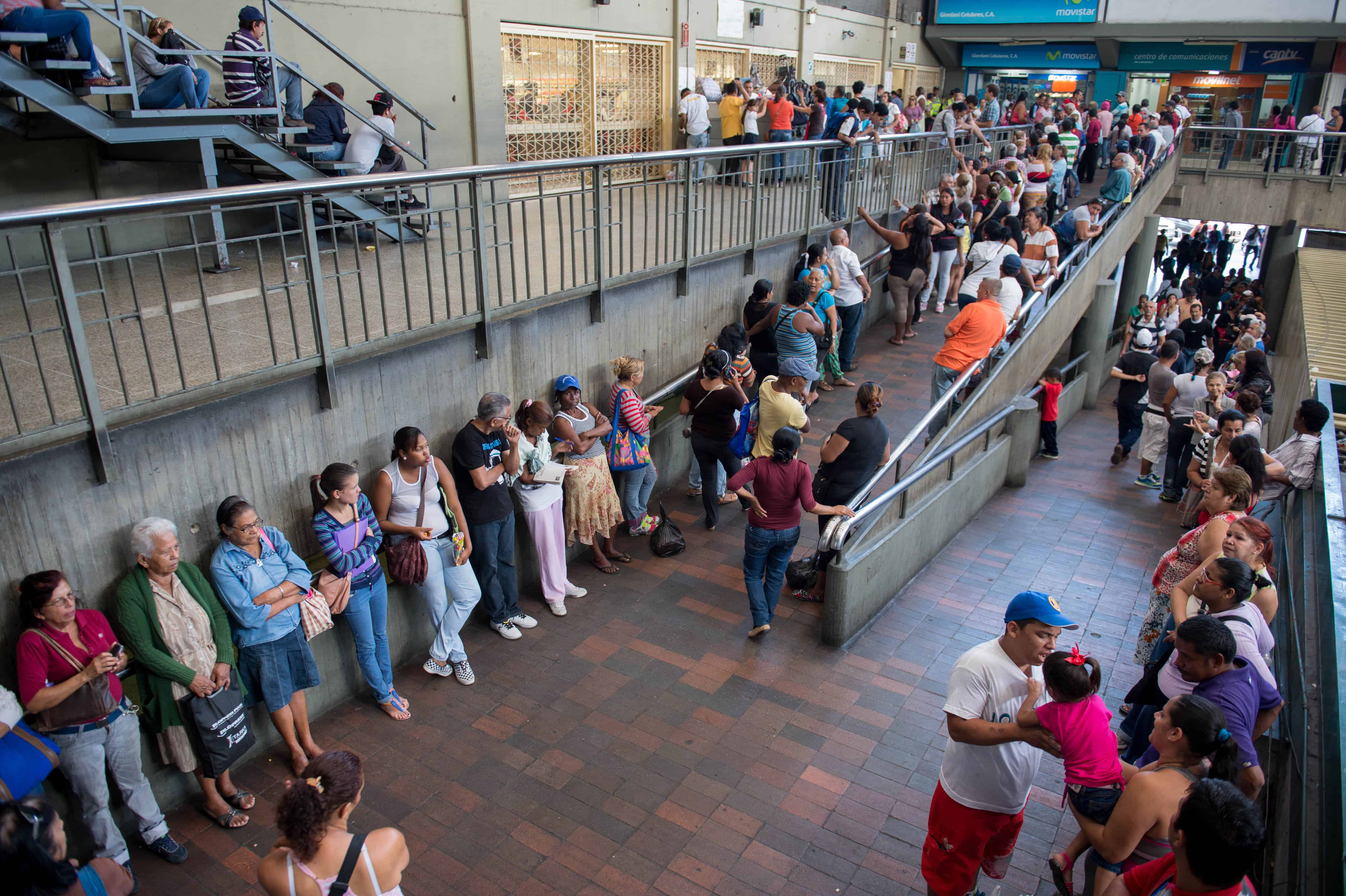 People queue up outside a supermarket in Caracas on Jan. 13, 2015.