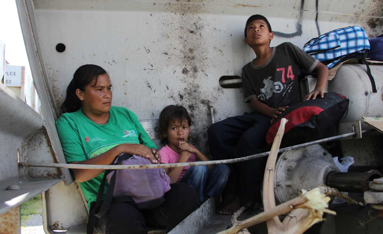A Central American immigrant and her children sit inside the so-called 