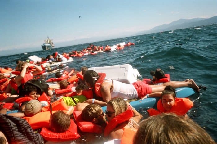 Survivors of the Pura Vida Princess catamaran accident cling to life preservers and floating coolers in the Gulf of Nicoya on Jan. 9, 2015. Three tourists drowned when the vessel capsized in rough seas.