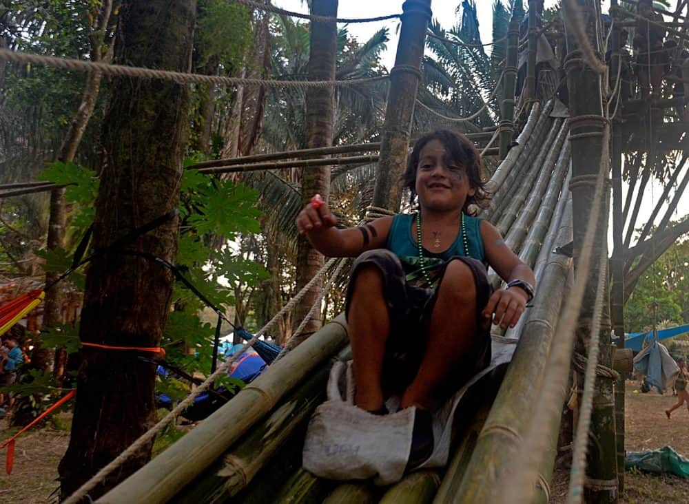 A child heads down the bamboo slide in the Envision village.