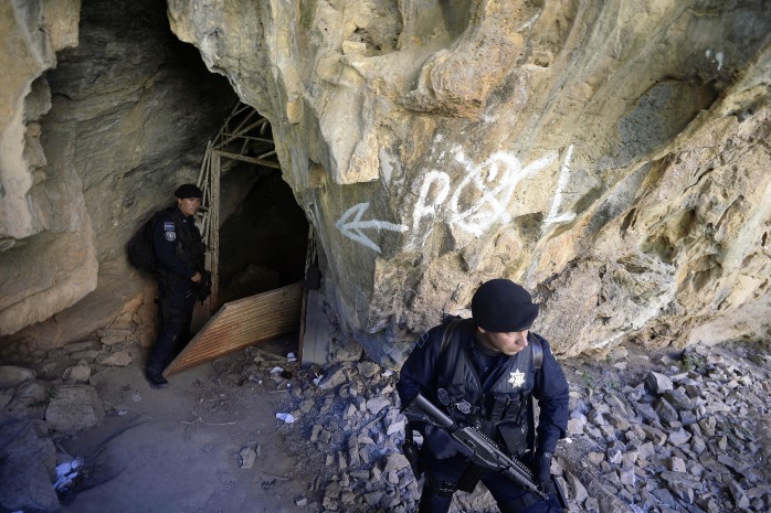 Mexican federal police guard the entrance of a cave where Servando Gómez, aka "La Tuta," had been hiding.