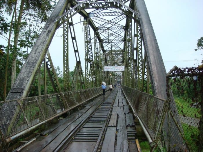 Pedestrians cross the railroad bridge over the Sixaola River, the natural border dividing Panama and Costa Rica, on Aug. 18, 2007.