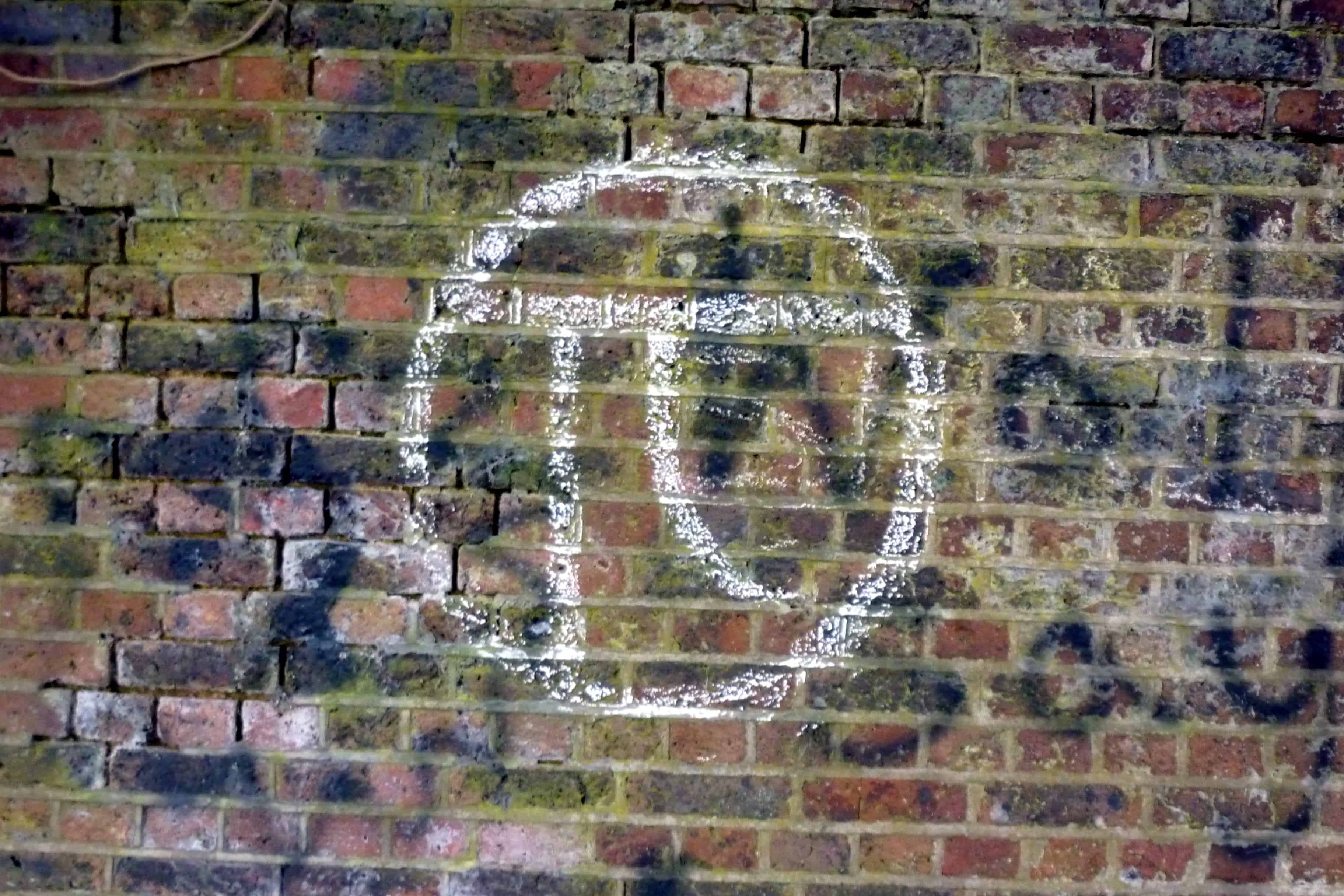 The pi symbol graffitied on a wall in London.