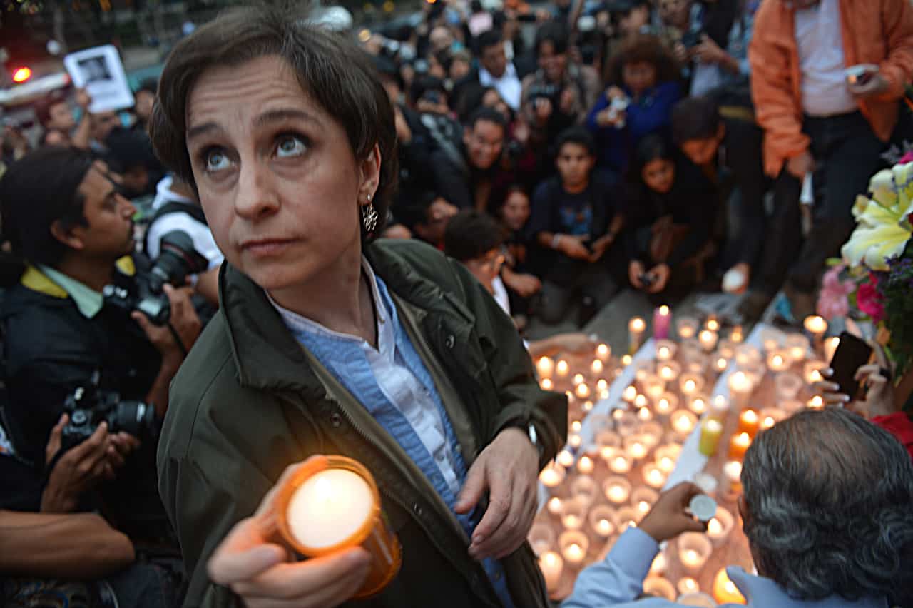 Mexican journalist Carmen Aristegui places a candle on an altar erected at the Independence Angel monument in Mexico City on May 5, 2012 during a vigil to protest against violence towards the press.