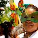 A celebrant wears a “carnavales” mask.
