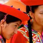 Young women dressed in traditional Colombian garb wait to perform.