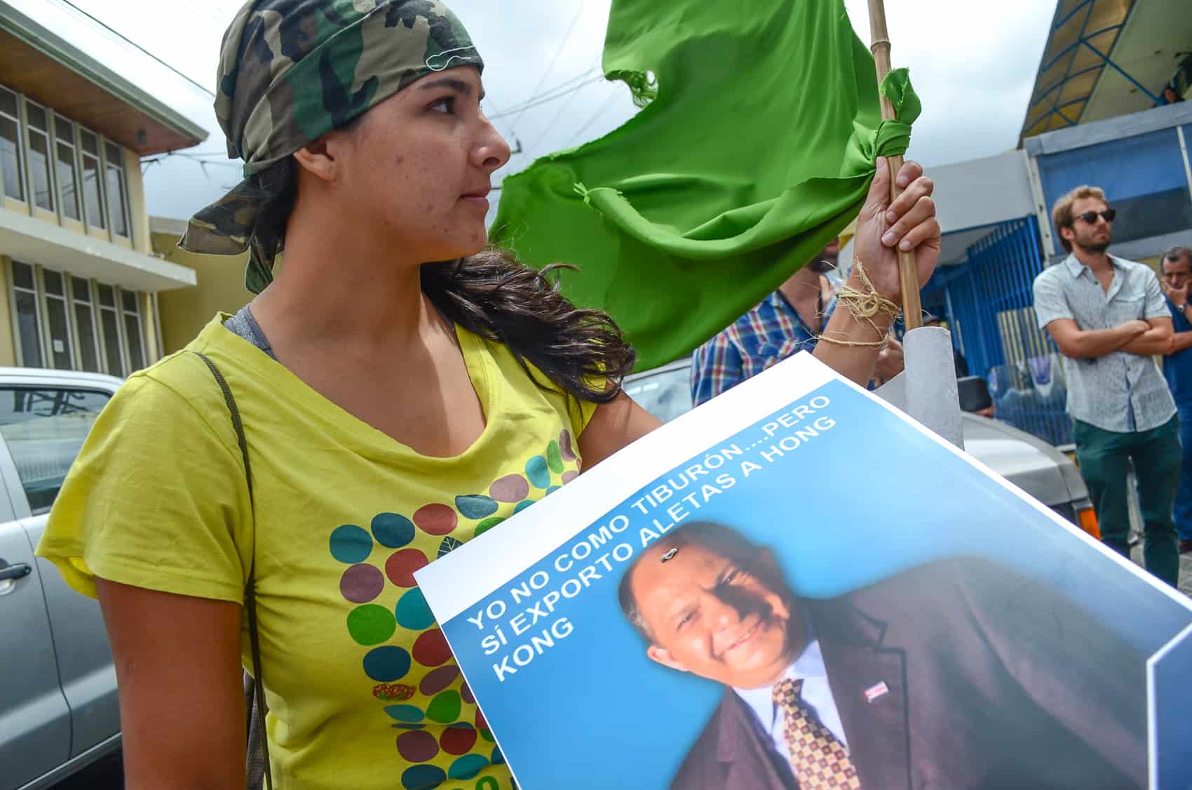 Shark Enemy of the Year: A protester holds a sign of President Luis Guillermo Solís.