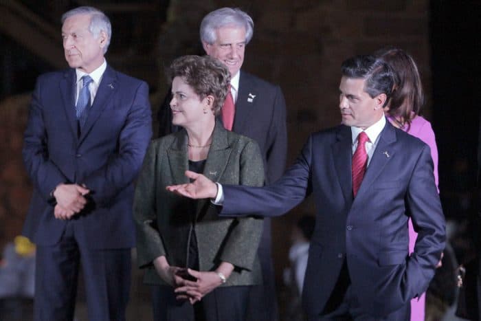 Mexican President Enrique Peña Nieto, right, talks to Brazil's President Dilma Rousseff while Chilean Foreign Minister Heraldo Munoz, left, and Uruguay's President Tabare Vázquez look on.