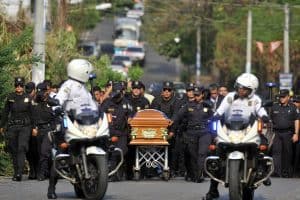 Members of El Salvador's police force attend the funeral of Wendy Yamileth Alfaro Mena, in Zacatecoluca, 65 km east from San Salvador on April 22, 2015.