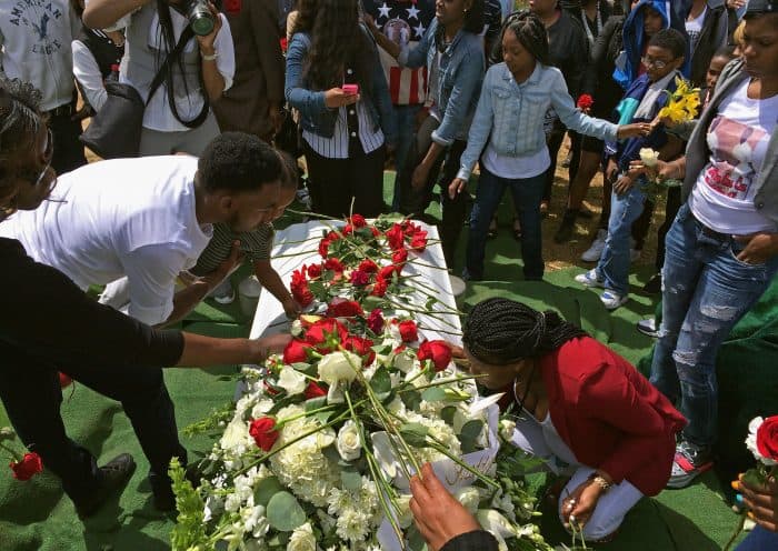 Friends and relatives lay flowers on Freddie Gray's casket.