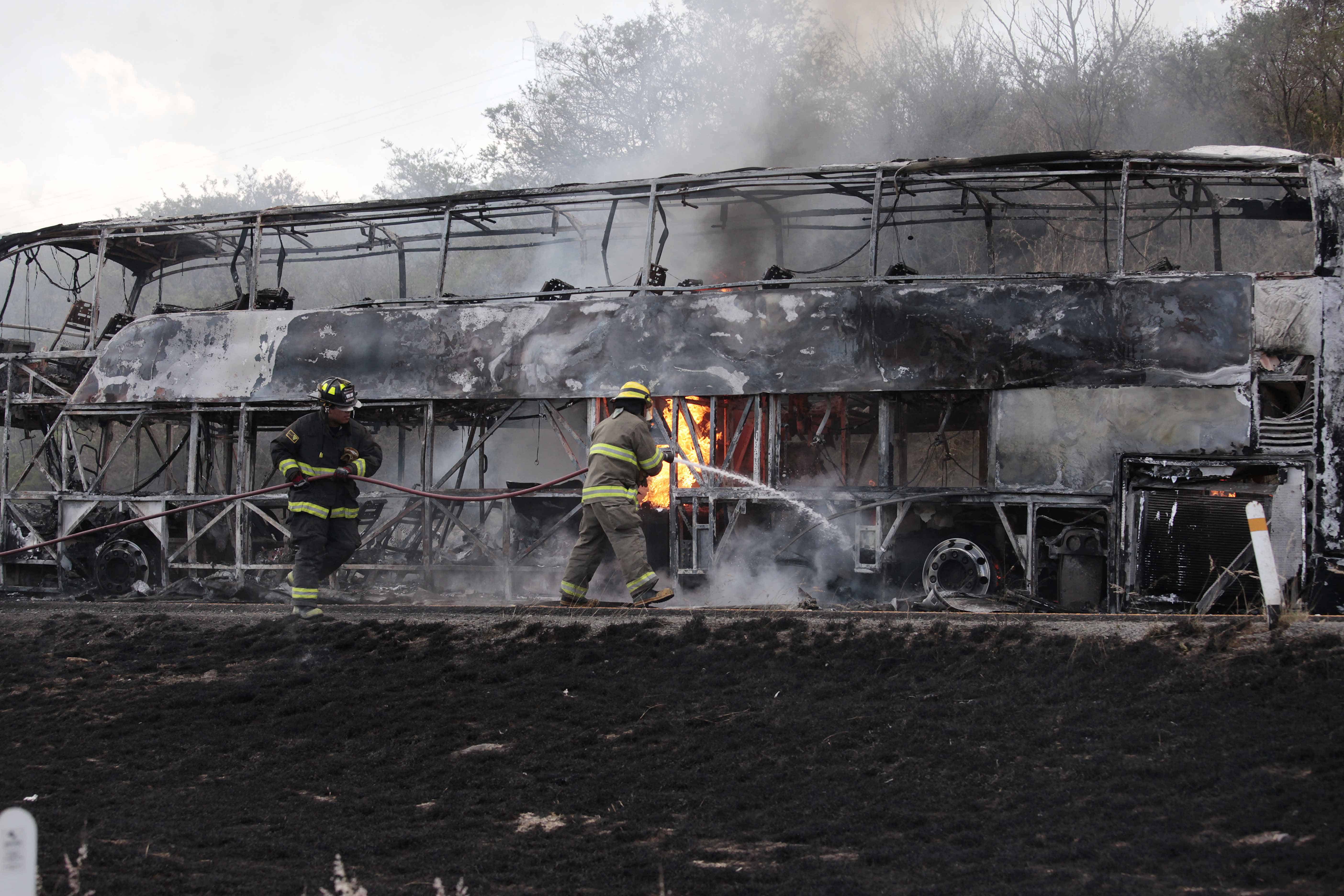 Firefighters extinguish a burning bus in Mexico.