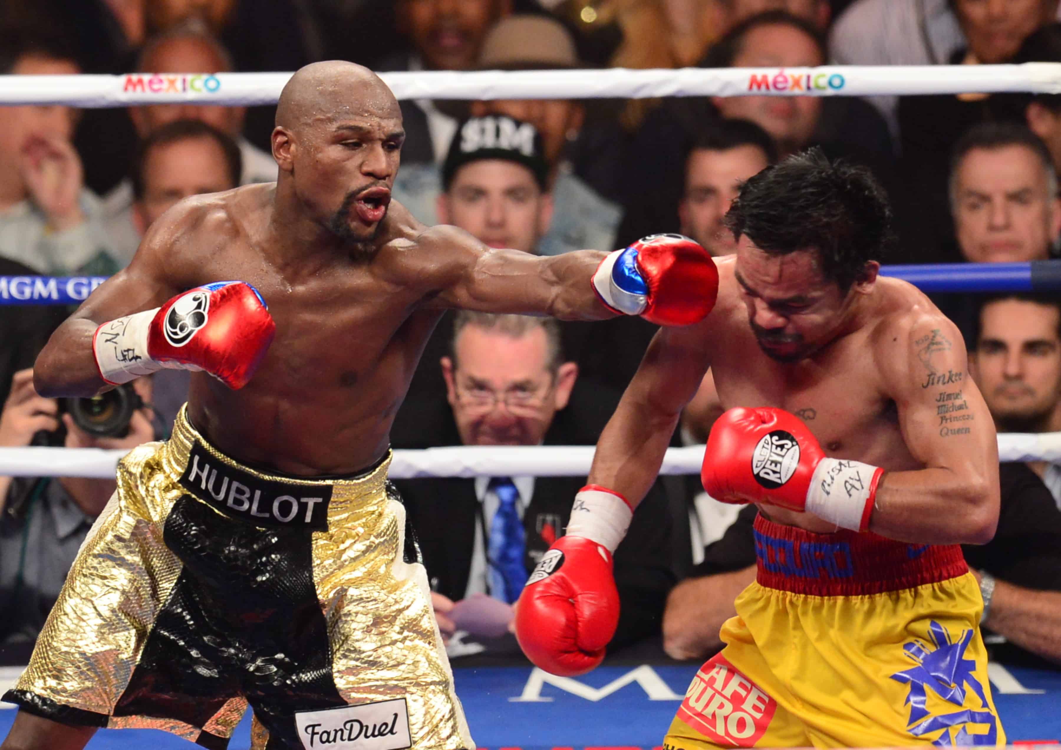 Floyd Mayweather Jr., left, connects against Manny Pacquiao.