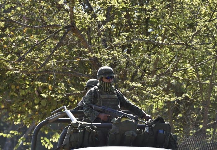 Soldiers of the 88th infantry brigade patrol the area around the site where a military helicopter was shot down.