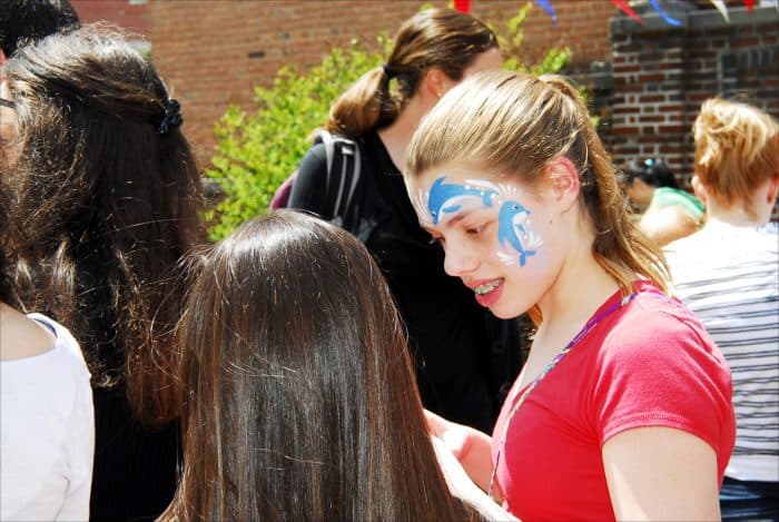 Skye Sunderhauf, 11, shows off her newly painted face to her friend at the Embassy of Costa Rica, during Passport DC festivities Saturday, May 2.