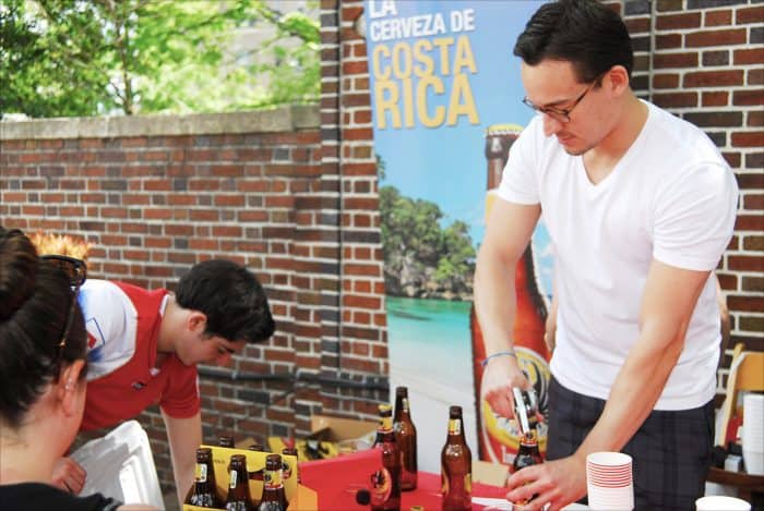 Erick Marín opens bottles of Imperial beer for visitors to the Embassy of Costa Rica.