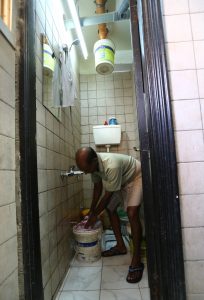 Kupttamon, an Indian laborer working in Qatar, washes his bed blankets.