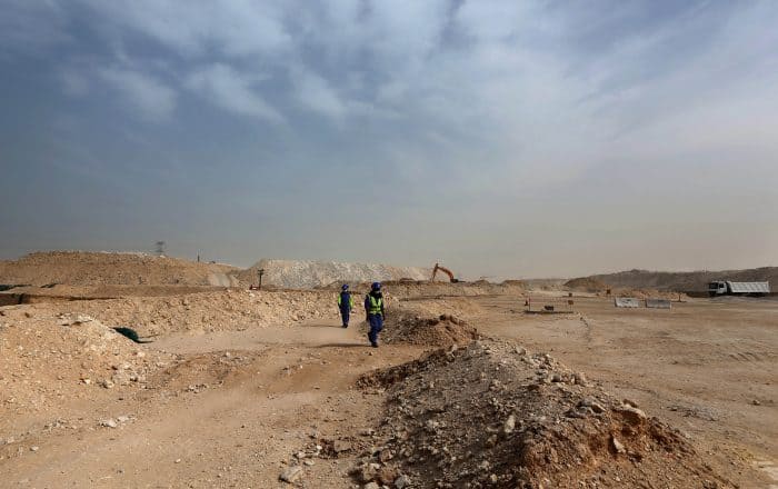 Foreign laborers work at the construction site of the al-Wakrah football stadium.