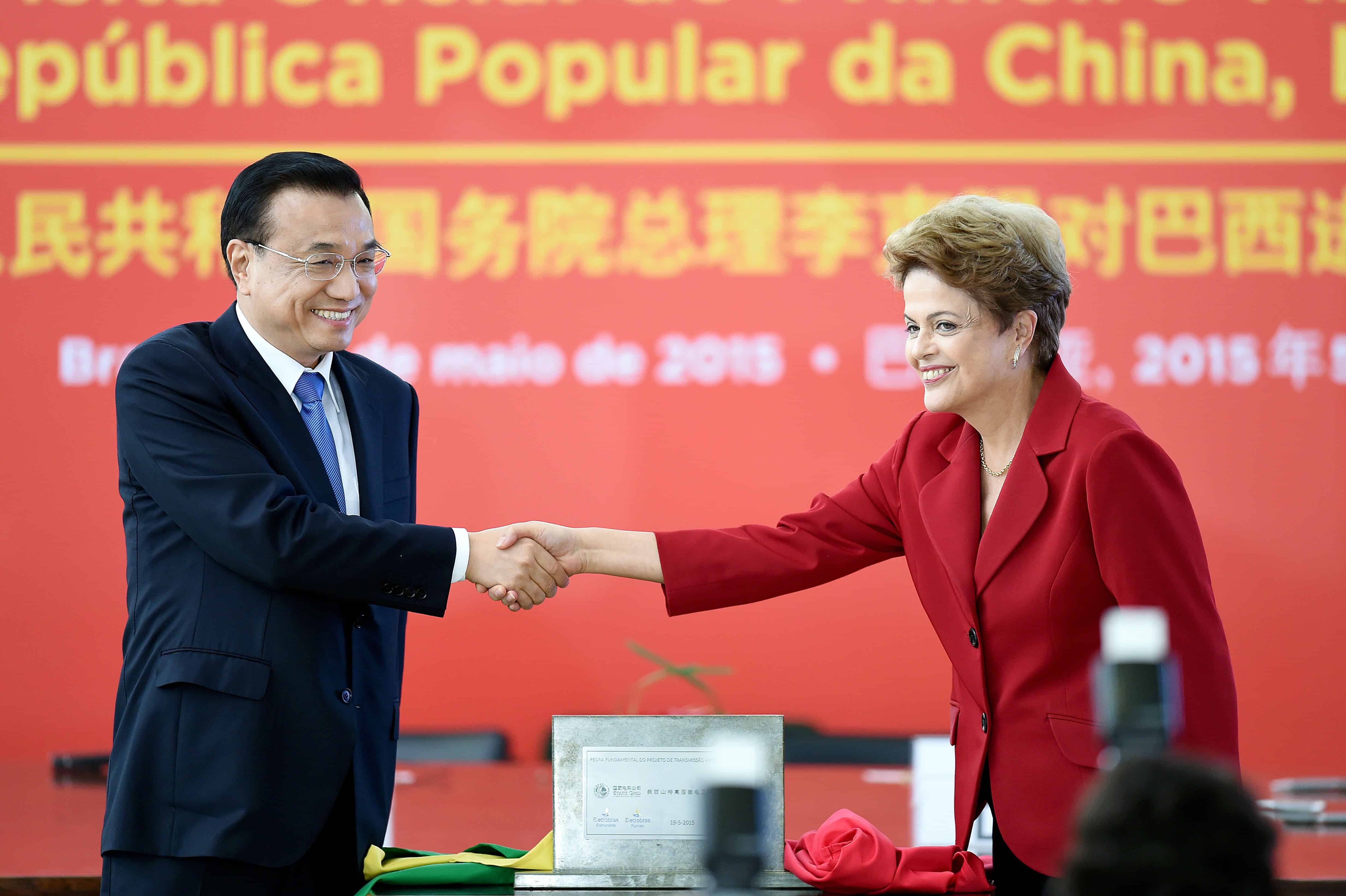 China's Prime Minister Li Keqiang, left, and Brazilian President Dilma Rousseff shake hands.
