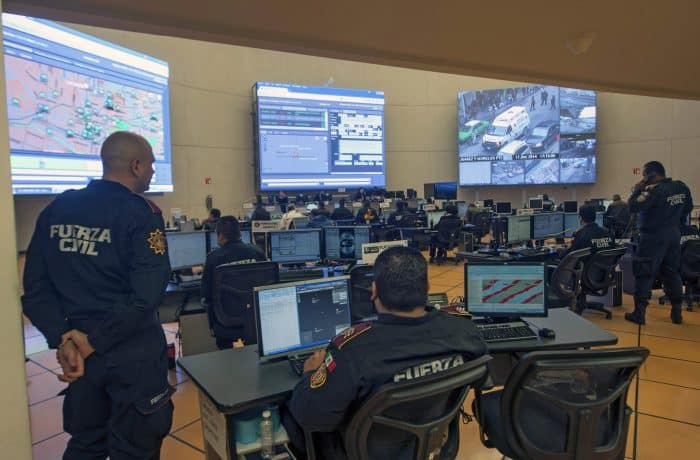 Members of the Civil Police Force watch screens at the Integral Coordination Center of Control, Command, Communications and State Count (C-5).