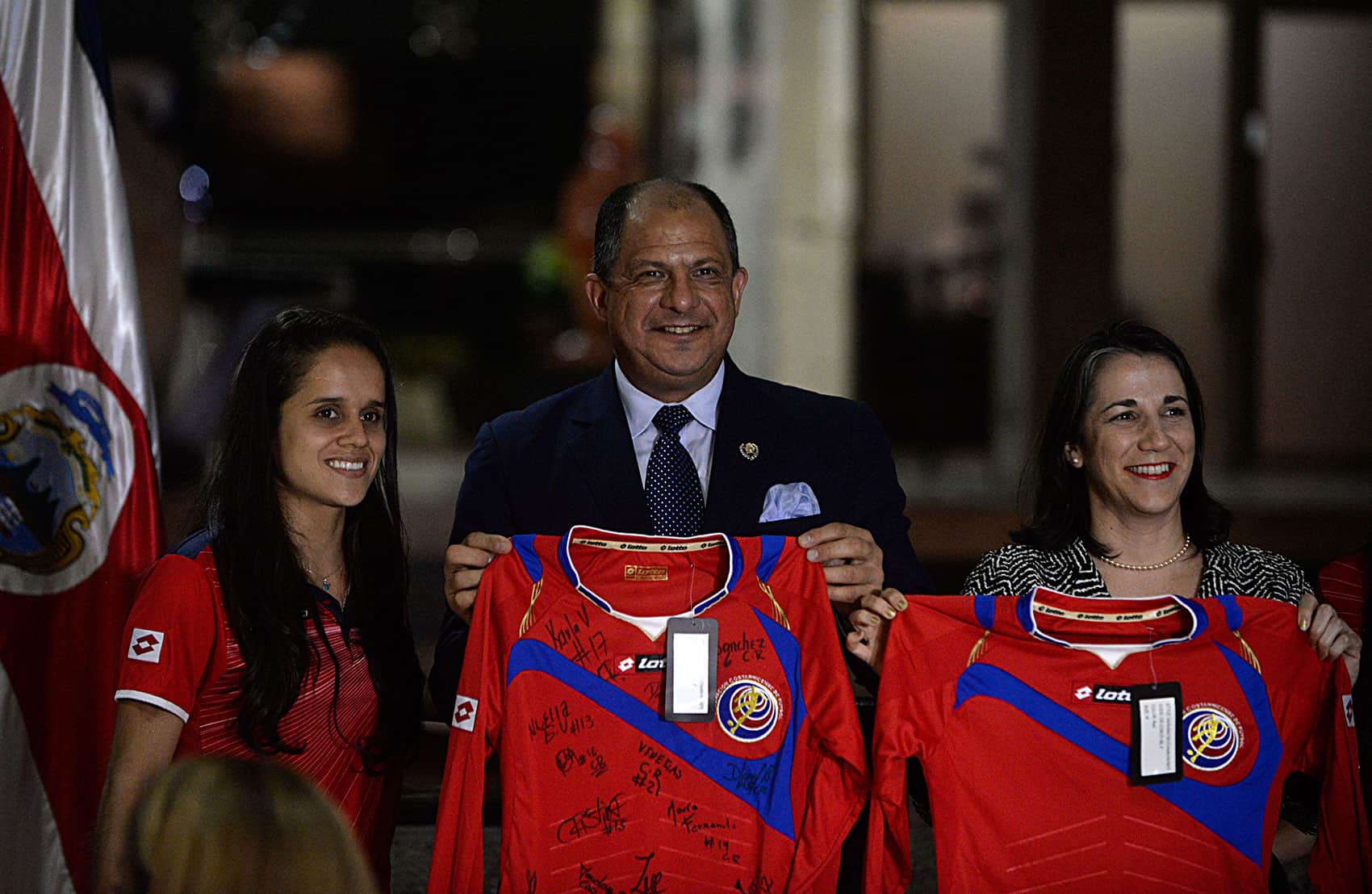 Las Ticas captain Katherine Alvarado stands with President Luis Guillermo Solís and First Lady Mercedes Peñas at a dinner honoring the Costa Rican Women's World Cup team on May 11, 2015.