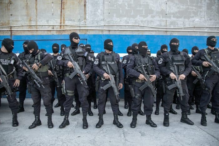 Anti-gang police officers receive instructions for an operation in a dangerous neighborhood in San Salvador.