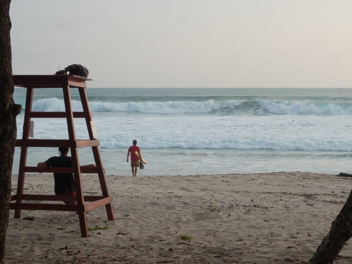 A Santa Teresa lifeguard stands at the water’s edge.