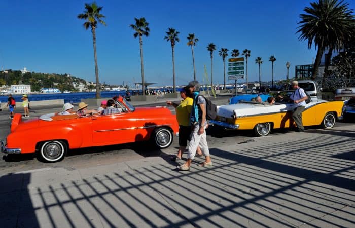 Tourists from the United States are seen in old American cars in Havana.