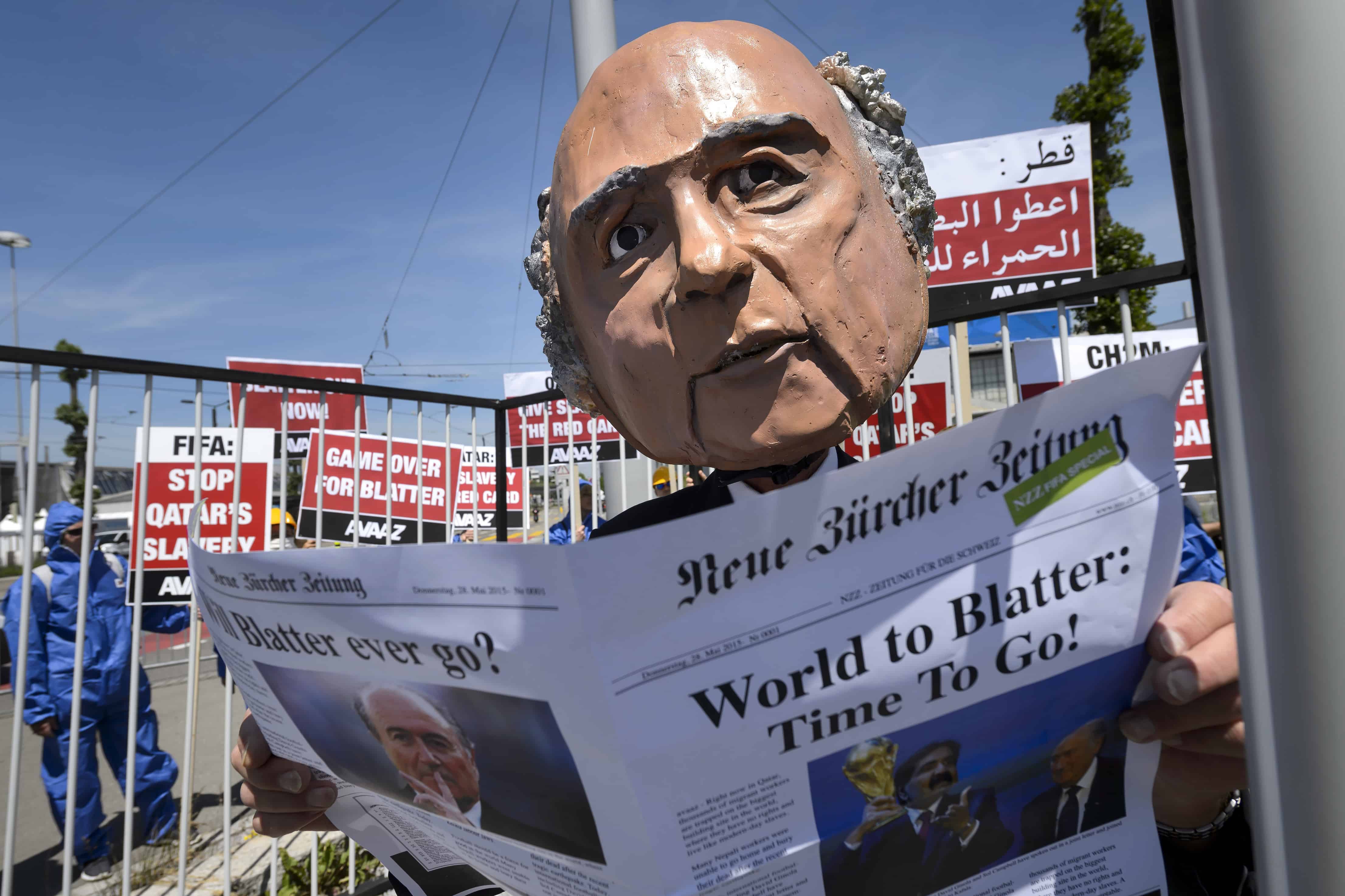 A demonstrator disguised as FIFA President Sepp Blatter takes part in a protest against the condition of workers in Qatar.
