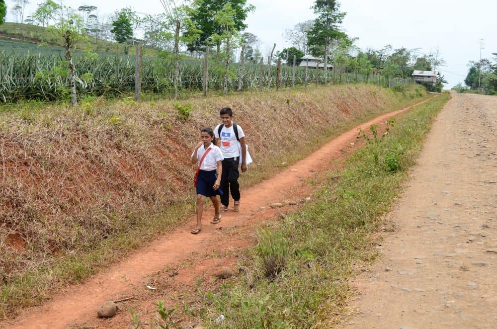 Nicaraguan school kids walk along Route 1856 in Costa Rica's northern Alajuela province,