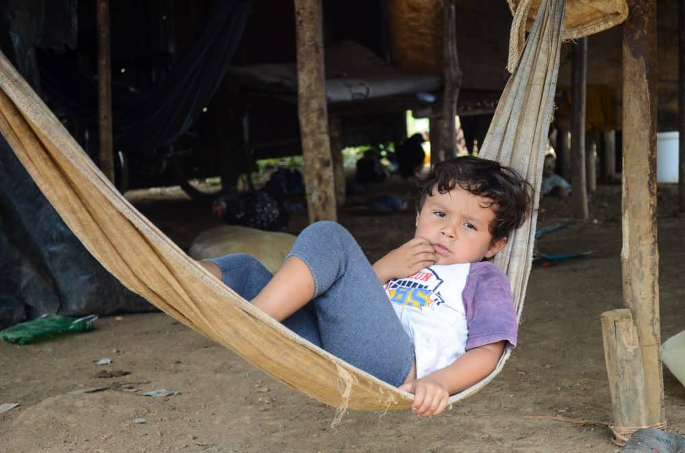 Boy outside of shack in northern Alajuela province, near Costa Rica's Los Chiles