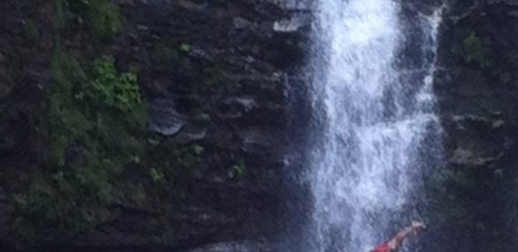 A tour guide dives off Nauyaca Waterfall.