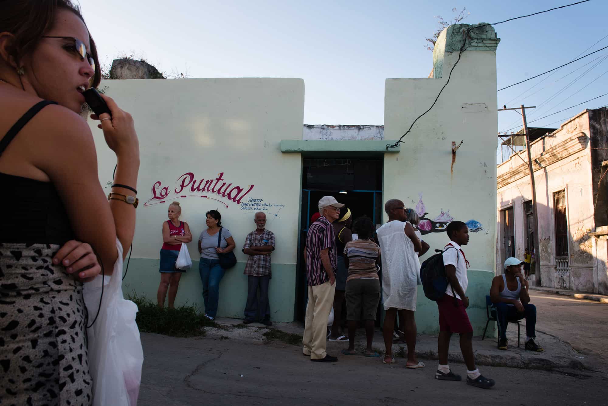 In the Cuban area of Regla, across the bay from Havana, people wait hours for their government ration of chicken.