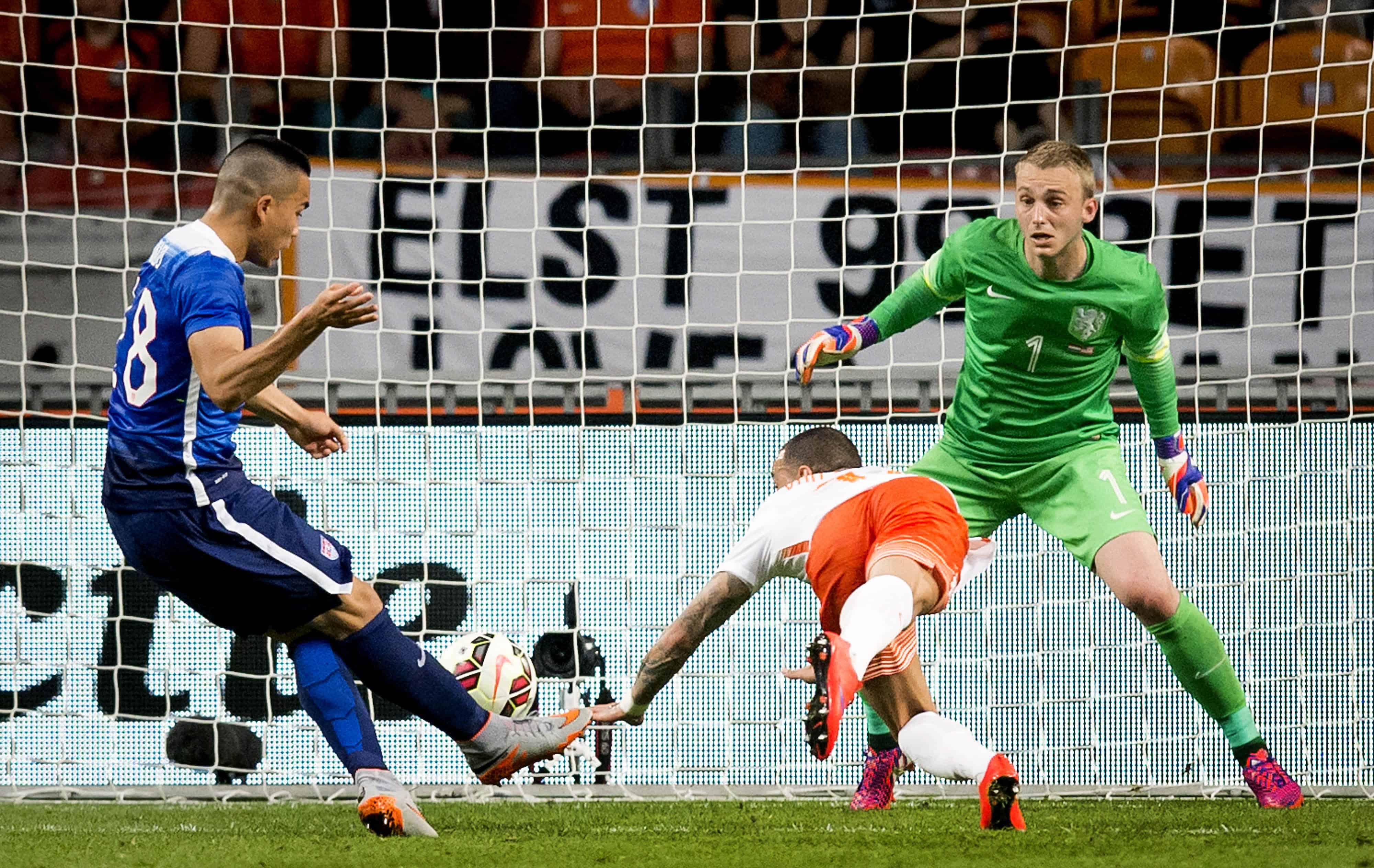 U.S. player Bobby Wood, left, scores a goal past the Netherlands' goalkeeper Jasper Cillessen.