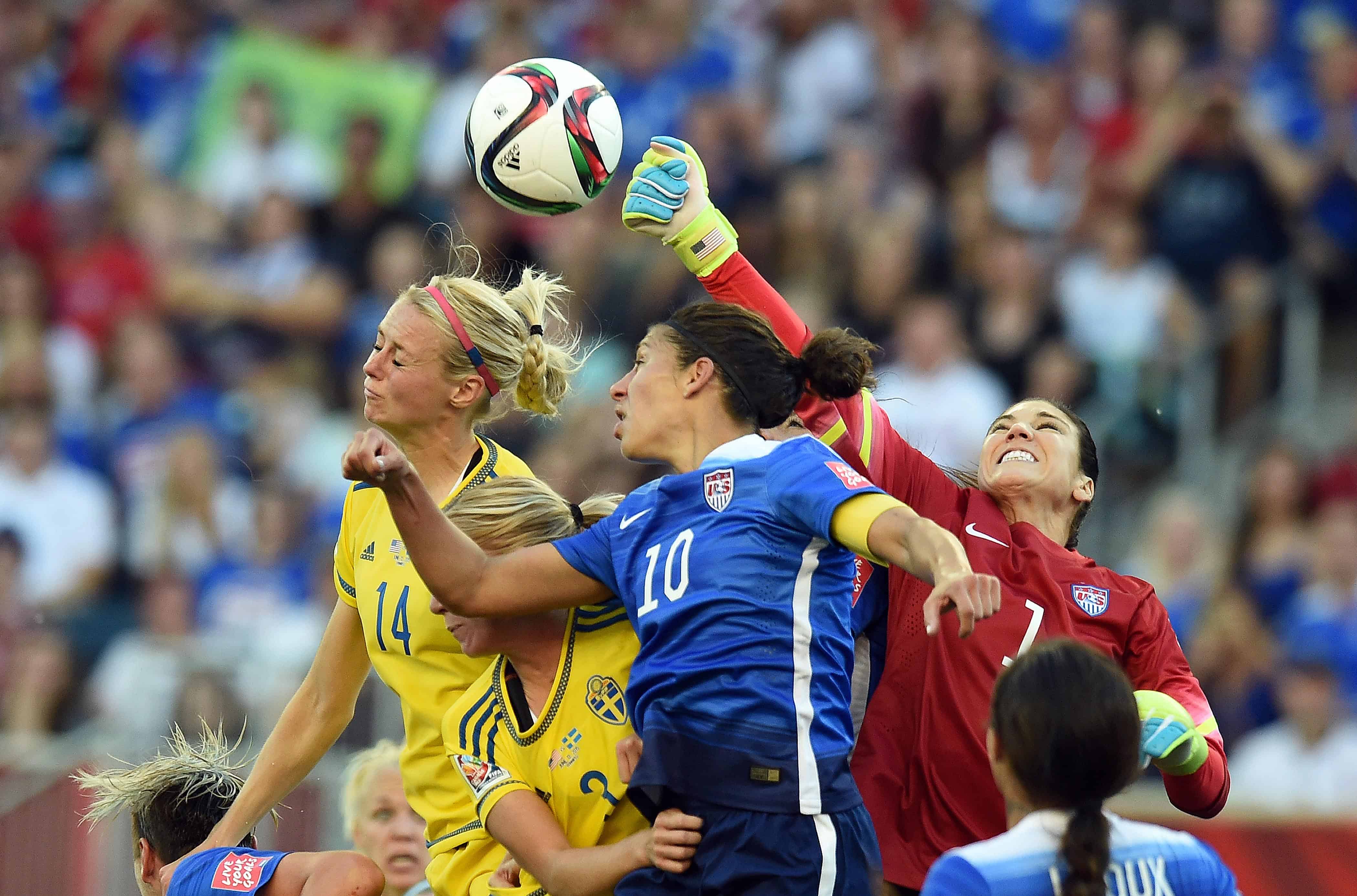 U.S. goalkeeper Hope Solo, right, punches the ball away.